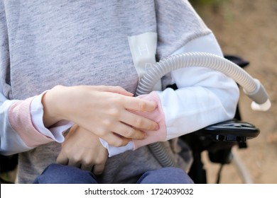 Hands of a disabled person with muscular dystrophy holding a ventilator for deep breathing, concept, background - Shutterstock ID 1724039032