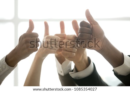 Hands of diverse business team people showing thumbs up like finger gesture as concept of recommendation or good job choice, celebrate great deal, racial equality, successful teamwork, close up view