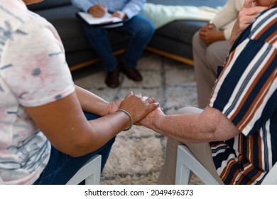 Hands of diverse senior women holding and supporting each other. senior health, support and lifestyle.