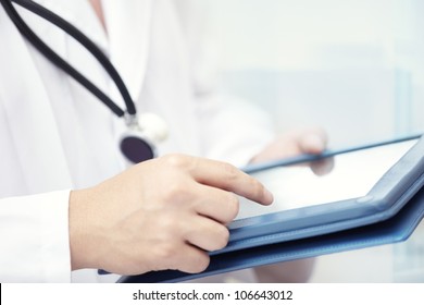 Hands Of Doctor Indoors Using Tablet Computer