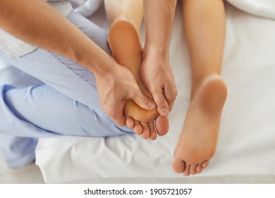 Hands of doctor masseur making manual massage of feet for lying woman in wellness clinic, top view. Professional chiropractor during work concept - Powered by Shutterstock