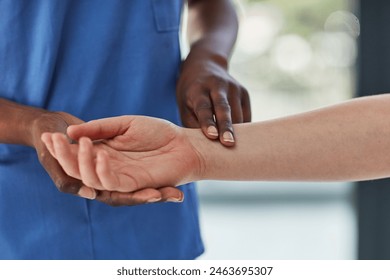 Hands, doctor and patient to check pulse, healthcare and diagnosis with procedure, technique and clinic. Closeup, medical and professional with person, wrist and help for heart rate and consultation - Powered by Shutterstock