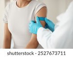 Hands, doctor and patient with plaster at clinic for vaccine injection, medical safety and virus protection. People, checkup and wound for immune system, drugs treatment and mpox pharmaceutical