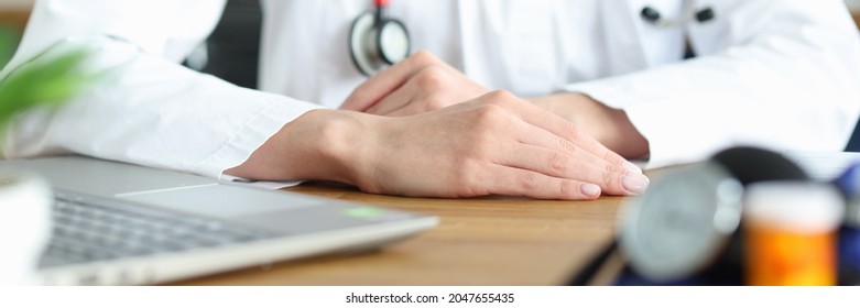Hands of doctor in white coat at workplace - Shutterstock ID 2047655435