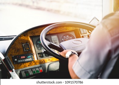 hands of driver on bus steering wheel