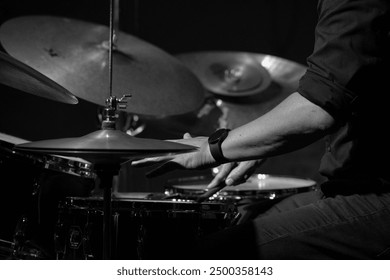 Hands of a drummer playing the drum set during a live jazz performance, highlighting the rhythm and energy of the moment. - Powered by Shutterstock