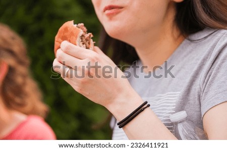 hands eagerly grab and devour food, representing hunger, sustenance, and the primal instinct of satisfying one's appetite