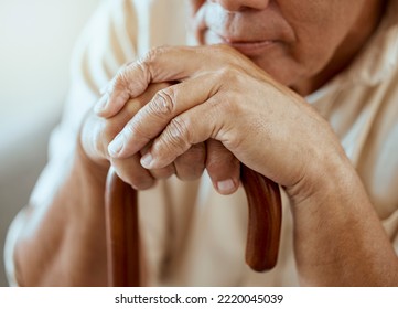 Hands Of Elderly Man On Walking Stick, Serious And Sitting Thinking, Memories At Retirement Home. Grandpa With Wooden Cane, Senior Care For Disability And Nostalgia For Sad Lonely Guy At Nursing Home