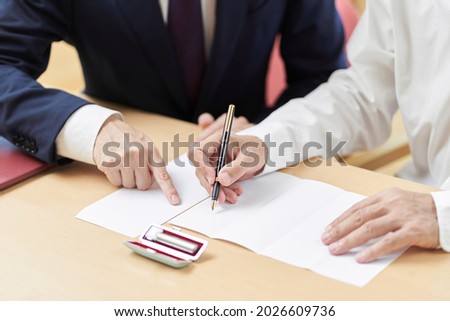 Hands of elderly people who consult with the profession about inheritance and wills
