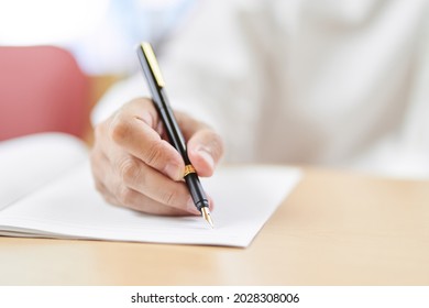 Hands Of Elderly People Writing Sentences With A Fountain Pen