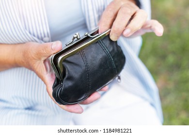 Hands Of An Elderly Woman Holding A Purse With Money, Pension