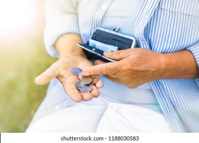 Hands Of An Elderly Woman Holding A Purse With Money, Pension