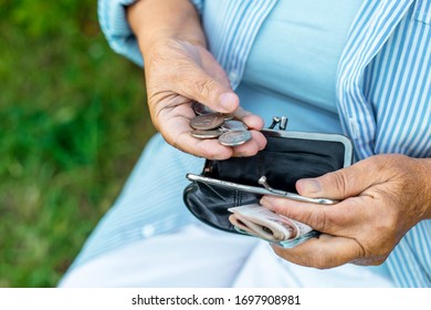 Hands Of An Elderly Woman Holding A Purse With Money, Pension