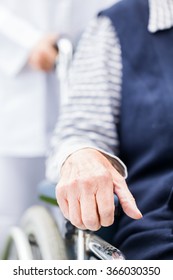 Hands Of An Elderly Woman Resting On The Wheelchair