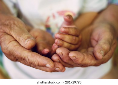 Hands of the elderly,old woman and child holding together.Love,Grandmother,