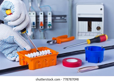 Hands Of Electrician With Screwdriver Tighten Up Switching Electric Actuator Equipment In Fuse Box