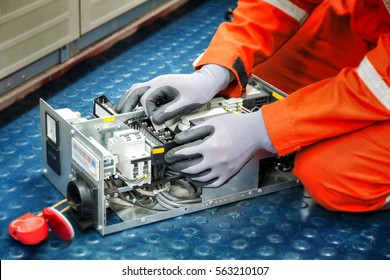 Hands Of Electricianduring Clean Up Switching Electric Actuator Equipment In Fuse Box