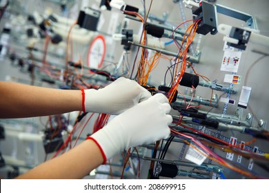 Hands employee that manufacture the wiring for the car