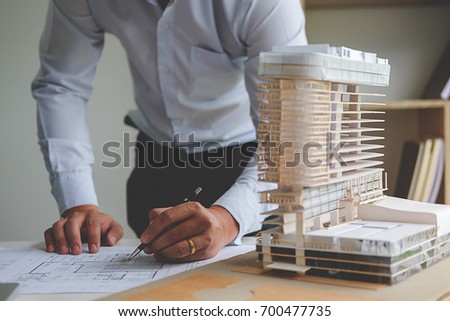 Hands of Engineer Working on Blueprint. Construction Concept. Engineering Tools.Vintage Tone Retro Filter Effect. Soft Focus(selective focus)