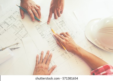 Hands of Engineer working on blueprint,Construction concept. Engineering tools. Vintage tone.