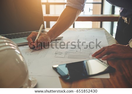 Hands of Engineer working on blueprint,Construction concept. Engineering tools.Vintage tone retro filter effect,soft focus(selective focus)