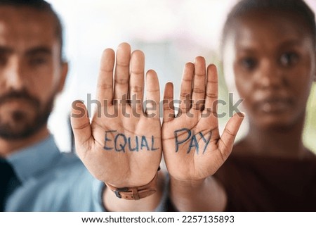Hands, equality and empowerment with a business man and woman showing an equal pay notice in their palms. Team, community and collaboration with male and female colleagues standing together in unity