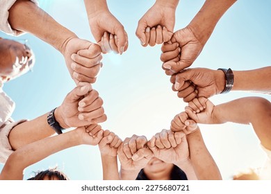 Hands, family and unity with a group of people in a huddle outdoor in nature during summer together. Sky, love or solidarity with parents, grandparents and children standing in a circle from below