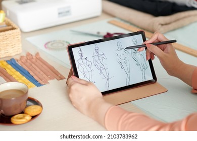 Hands Of Fashion Designer Drawing Sketch On Tablet Computer With Digital Pen