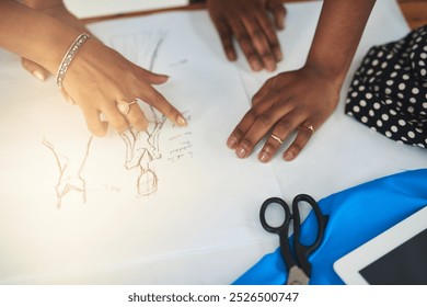 Hands, fashion designer and drawing together for clothes at workshop for review process, style and insight. Person, planning and sketch with creativity for garment, help or reading at small business - Powered by Shutterstock