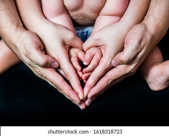 
HANDS OF A FATHER A MOTHER I A CHILD IN THE FORM OF A HEART - Shutterstock ID 1618318723