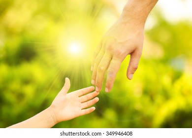 Hands of father and son holding each other