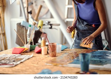 Hands of female artist working on new paint.Art studio. - Powered by Shutterstock