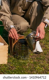 Hands Of Female Beekeeper Preparing Old Bee Smoker On Rooftop. Apiculture. Urban Beekeeping.