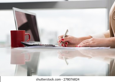 Hands of female bookkeeper working with documents, side view