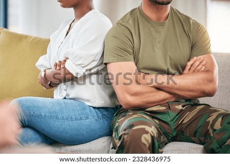Hands, fight and a couple with arms crossed on sofa in home living room. Angry, interracial divorce and a man and black woman with relationship problem, crisis or frustrated with marriage conflict.