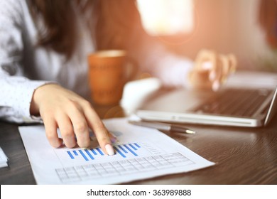 Hands of financial manager taking notes when working 
