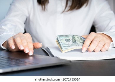 Hands of a financial worker in a white shirt counting money bills. A large bundle of money close-up.