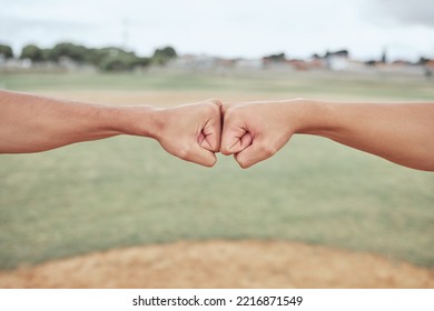 Hands, fist bump and friends outdoor in nature for partnership, friendship and support on a field. Baseball or softball pitch, team building and men athletes doing a solidarity gesture together. - Powered by Shutterstock