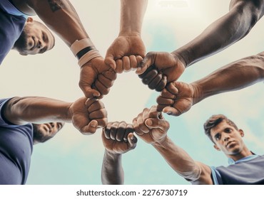 Hands, fist and solidarity with a sports team standing in a huddle for unity or motivation before a game. Fitness, teamwork and diversity with a group of men in a circle, getting ready for a match - Powered by Shutterstock