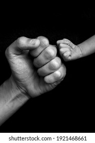 hands fists father and son on black background, black and white  - Shutterstock ID 1921468661