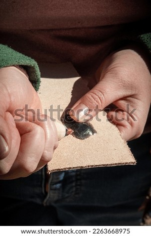 Hands Flint Knapping Stone Arrowhead using Obsidian