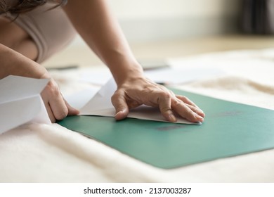 Hands Folding A Paper Airplane With Ruler On The Cutting Plate.