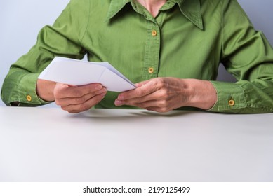 Hands Folding A Sheet Of Paper