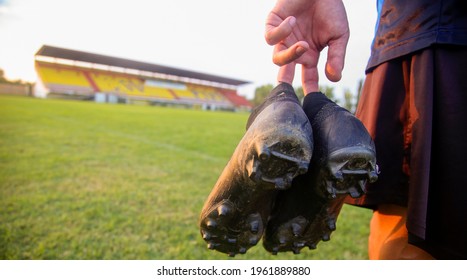 Hands Of Football Players Holding Football Boots On The Football Field