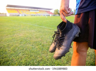 Hands Of Football Players Holding Football Boots On The Football Field