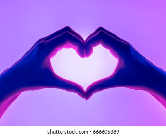 Hands in the form of heart red background. heart symbol with hand. valentines day card. Woman's hands silhouette in form of heart. hand Gestures