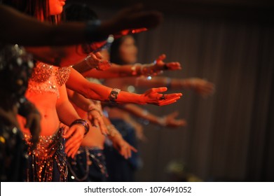 hands in a formation in a group belly dance recital practise