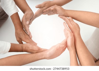 Hands forming circle of support and unity in diverse group showing cooperation and empathy, warm collaborative gesture conveying trust and connection