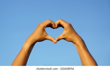 Hands Forming A Heart Shape With Blue Sky