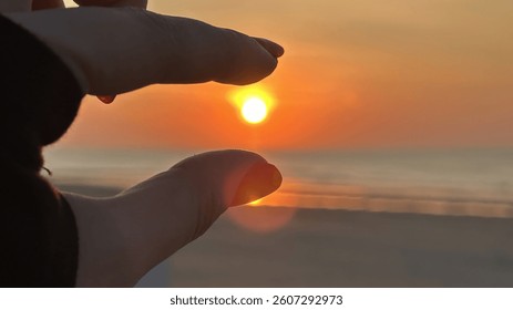 Hands Framing Golden Amber Sunset Over Ocean in Serene Moment, Selective Focus, Copy Space